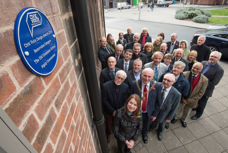 CovSoc members looking at plaque