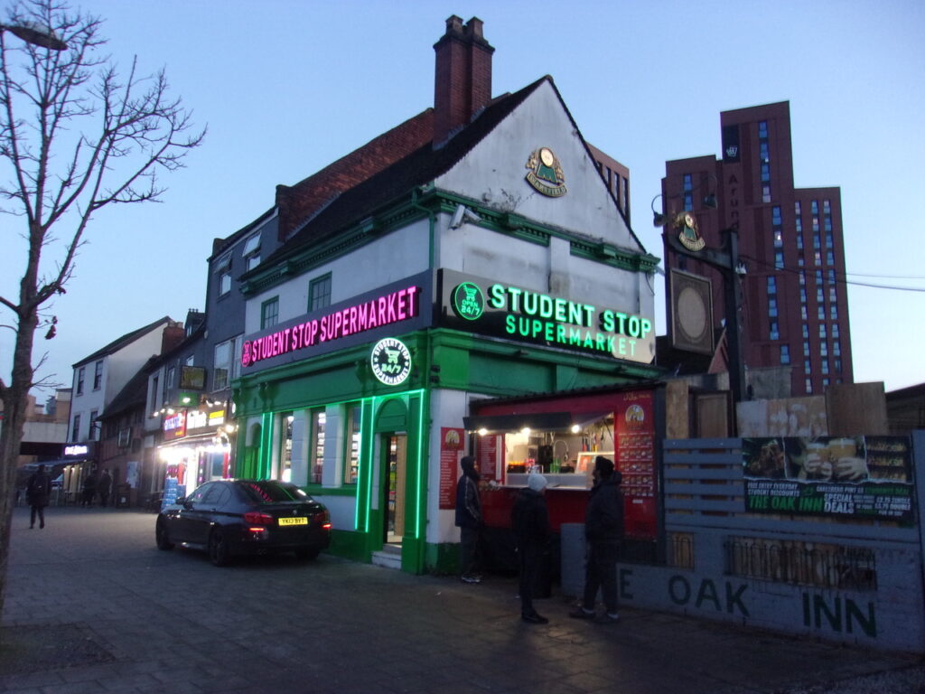 Oak Inn Gosford Street showing illuminated signs at dusk.