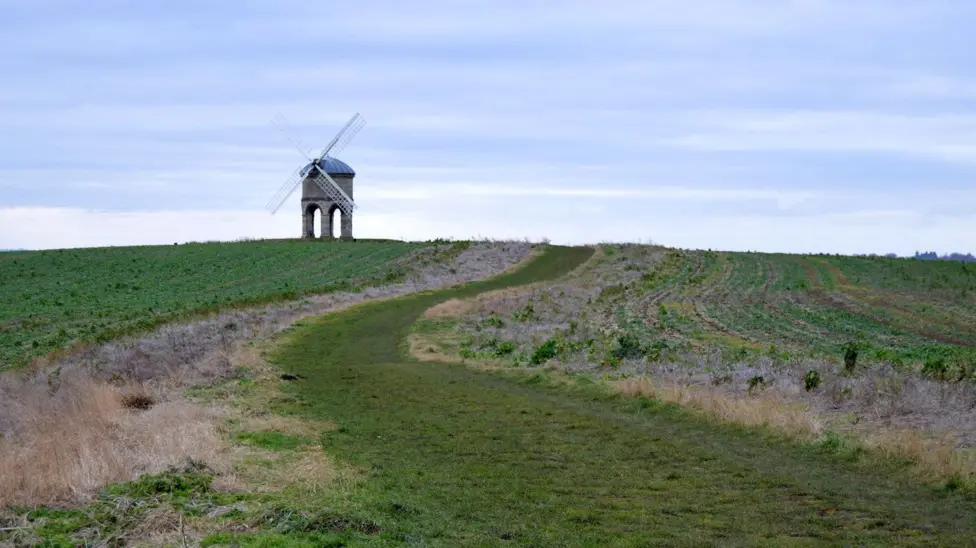 Coloured image of the windmill on the top of a hill with its sails in 2015.