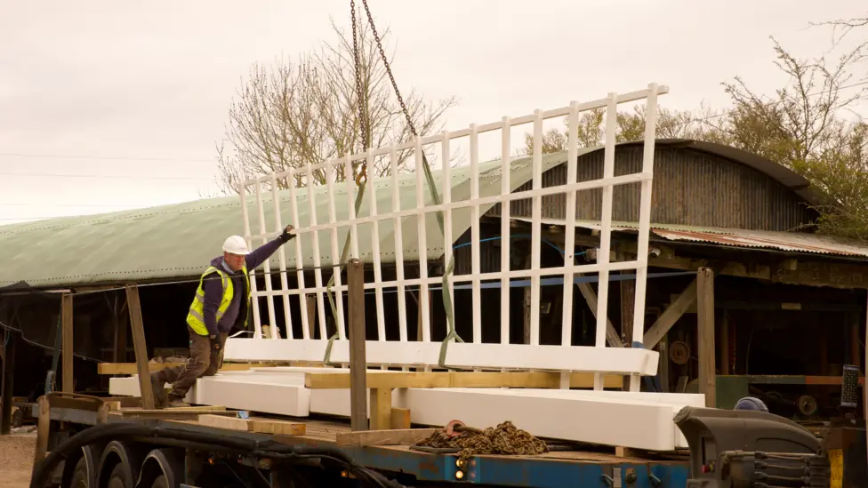 Image showing windmill sails on the back of a lorry being redied for delliery. 